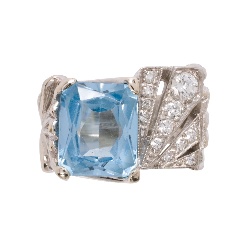 A blue spinel, diamond, and 14k white gold ring: A blue spinel, diamond, and 14k white gold ring Featuring a radiant-cut synthetic blue spinel weighing approximately 6.40 carats, accented by 12 single and round brilliant-cut diamonds weighing 0.45 c