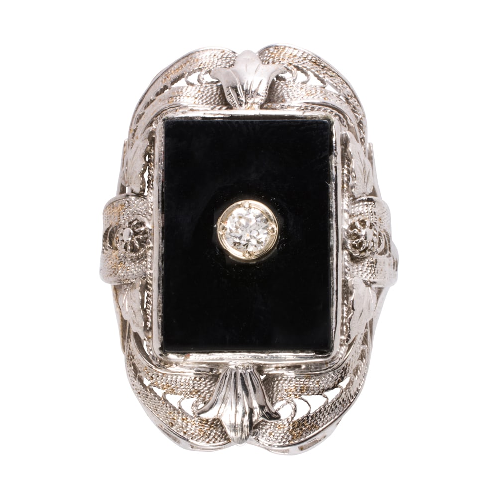 An antique onyx, diamond, and 14k white gold ring: An antique onyx, diamond, and 14k white gold ring Featuring an onyx tablet measuring 16.16 x 11.42 mm, accented by one transitional-cut diamond, set within ornate, open-form bezel; size 6 3/4; 7.10