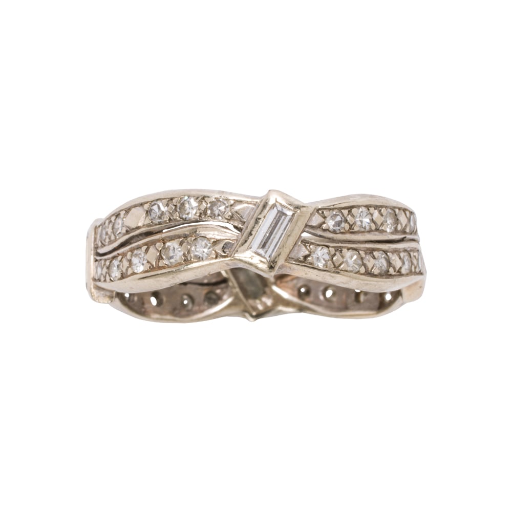 A diamond and 14k white gold eternity band: A diamond and 14k white gold eternity band Designed with 40 single-cut diamonds, interspersed by four baguette-cut diamonds; estimated total diamond weight: 2.00 carats; size 9 1/2; 4.35 grams