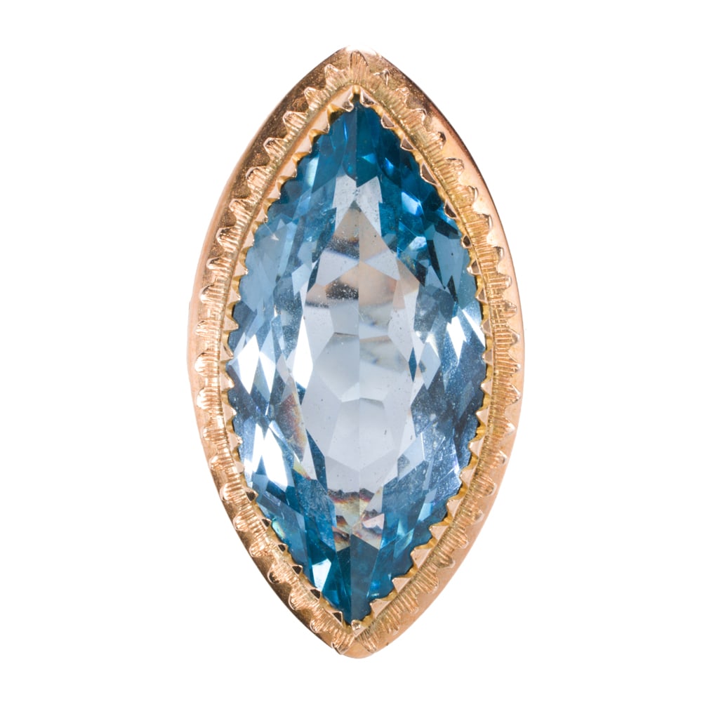 A topaz and 14k gold ring: A topaz and 14k gold ring Centering a marquise-cut topaz measuring 26.34 x 13.14 x 7.76 mm, set within decorative bezel; size 7; 10.00 grams