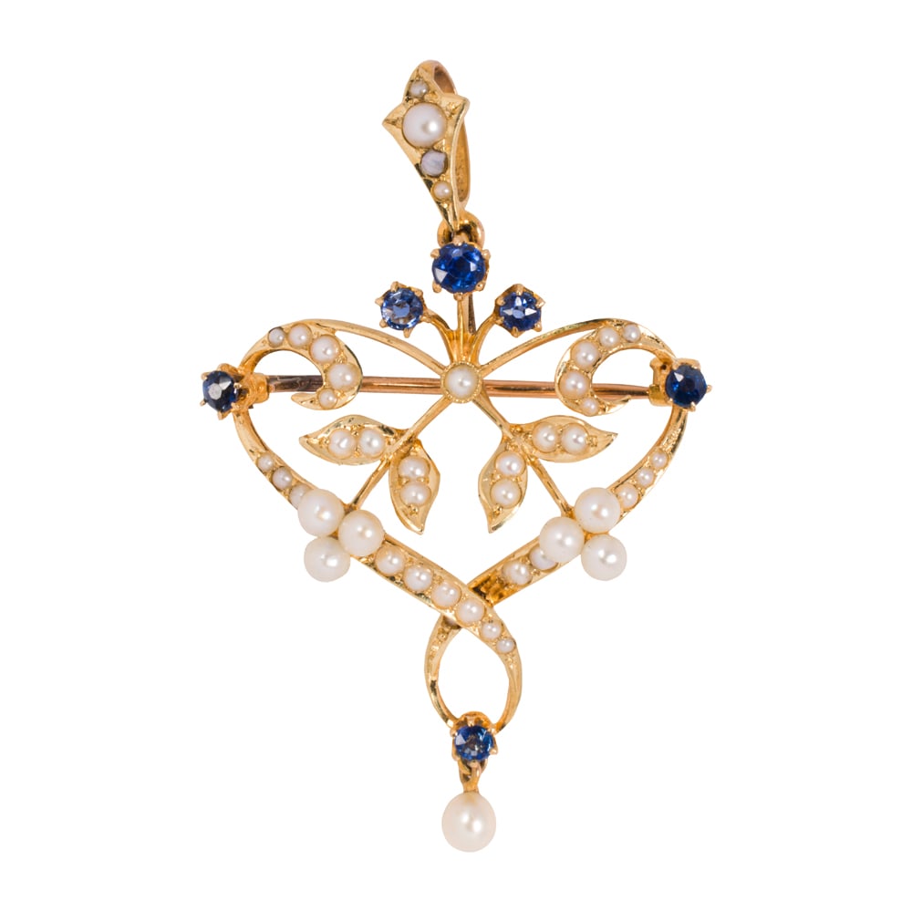 An antique seed pearl, sapphire and 15k gold brooch pendant: An antique seed pearl, sapphire and 15k gold brooch pendant set throughout with seed and half pearls, and accented by six round sapphires; length: 2 7/8 in; 4.81 grams