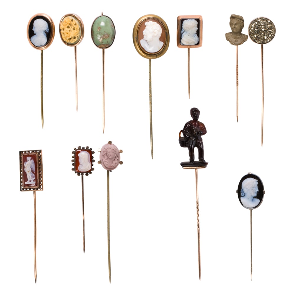 A collection of stickpins: A collection of stickpins comprising 12 pins set with assorted stones including hardstone and lava cameos, bone, druzy pyrite quartz, and turquoise, in 9k-14k gold and metal; lengths: 2 1/2 - 4in;