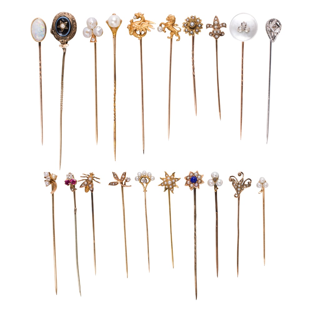 A collection of gem-set stickpins: A collection of gem-set stickpins comprising 20 stickpins variously set with stones including seed pearls, cultured pearls, river pearls, mother-of-pearl, diamonds, opal, lapis, ruby, and agate, with