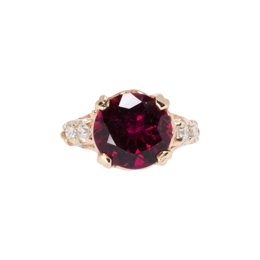 A rubelite tourmaline diamond and 14k gold ring: A rubelite tourmaline diamond and 14k gold ring centering a circular-cut rubelite tourmaline weighing approximately 2.90 carats, with round brilliant-cut diamond shoulders; estimated total diamond