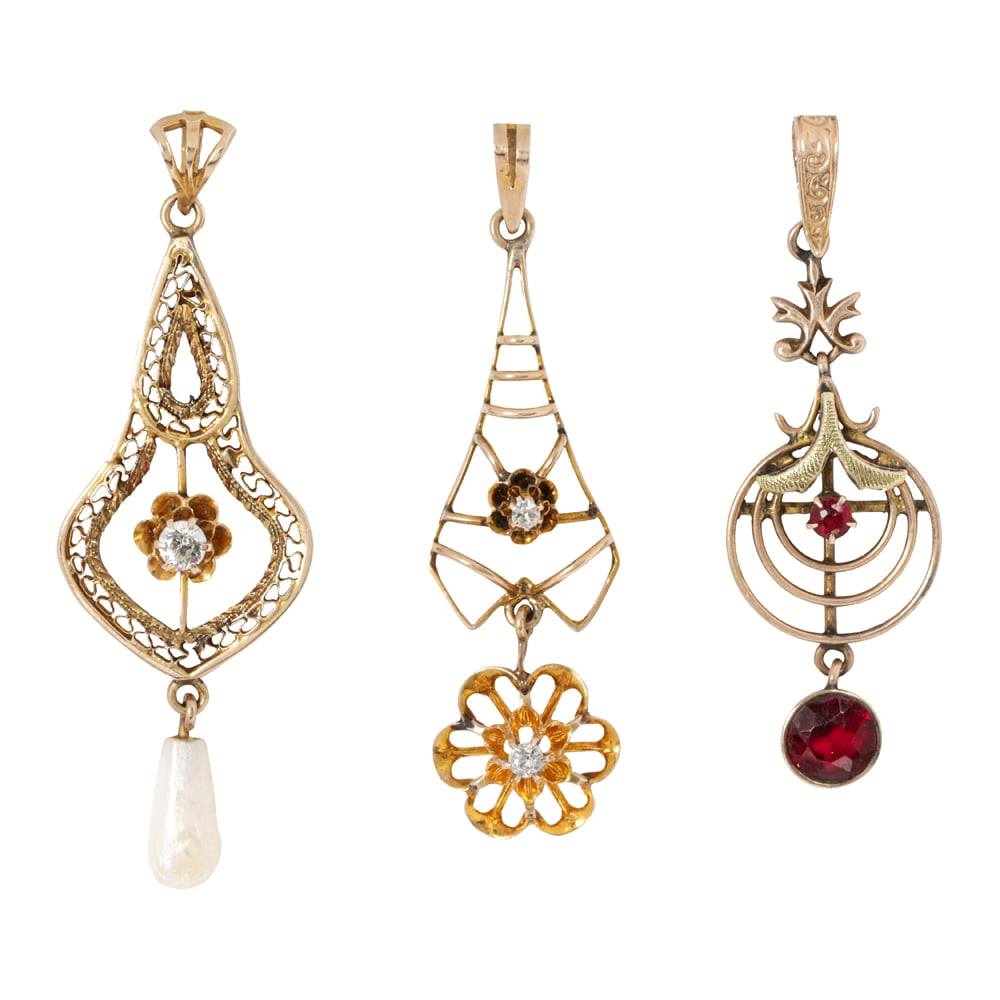 Three antique gold lavalier pendants: Three antique gold lavalier pendants one 14k gold set with a European-cut diamond and river pearl, one 10k gold with two old single-cut diamonds, and one 10k green and yellow gold with red glass;