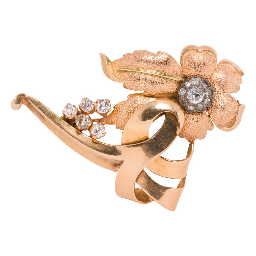 A Retro diamond and 18k gold flower pin: A Retro diamond and 18k gold flower pin Designed as a flower, accented by 15 old mine-cut diamonds weighing a total of approximately 0.85 carat; length: 2 in; 9.85 grams