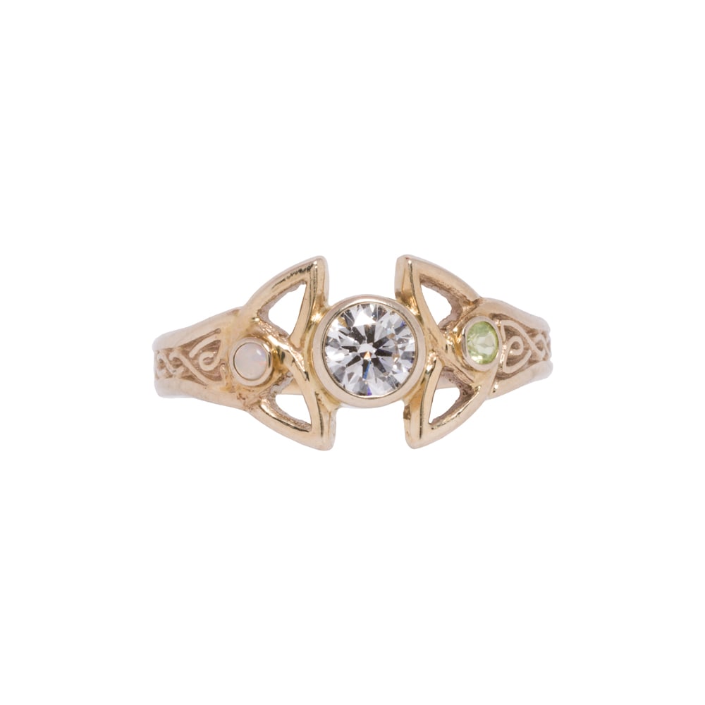 A diamond, opal, sapphire, and 14k gold ring: A diamond, opal, sapphire, and 14k gold ring Of Celtic knot design, featuring a round brilliant-cut diamond weighing approximately 0.40 carat, framed by one round shaped opal cabochon and one