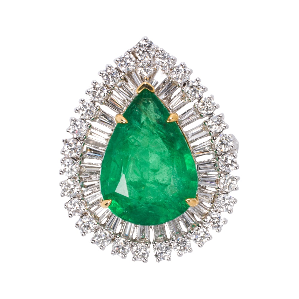 An emerald, diamond, and 14k gold ring: An emerald, diamond, and 14k gold ring Centering a pear-cut emerald weighing 6.98 carats, framed within halos of round brilliant and baguette-cut diamonds; size 7 1/4; 7.95 grams Accompanied by IGI