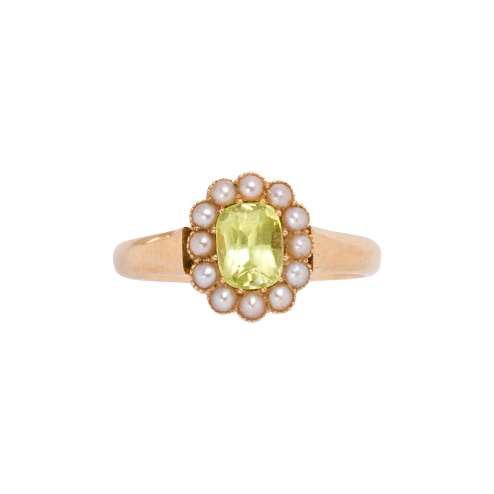 A spinel, seed pearl, and 18k gold ring: A spinel, seed pearl, and 18k gold ring Centering an oval-cut green spinel weighing approximately 0.80 carat, framed by 12 seed pearls, C. 1945; size 6 3/4; 3.85 grams