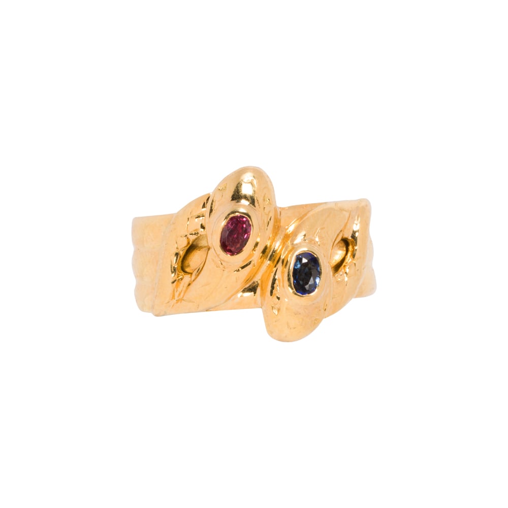 A ruby, sapphire, and 18k gold snake ring: A ruby, sapphire, and 18k gold snake ring Designed as intertwined snakes, set with one oval-cut ruby and sapphire; size: 6; 3.00 grams