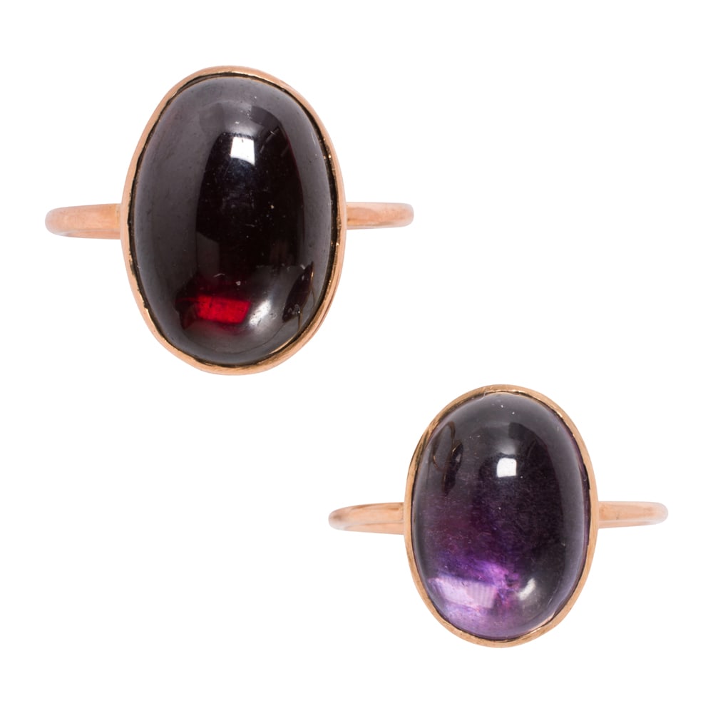 Two antique garnet, amethyst, and 14k rose gold rings: Two antique garnet, amethyst, and 14k rose gold rings Both with close-backed stones, one oval-shaped garnet cabochon measuring 13.75 x 9.65 mm, and one oval-shaped amethyst cabochon measuring 12.00 x 