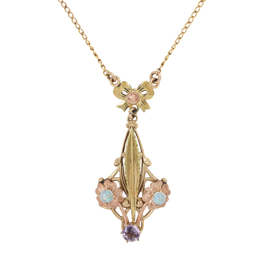 An antique amethyst, opal, and 10k bi-color gold necklace: An antique amethyst, opal, and 10k bi-color gold necklace Of open-form lavalier design, set with two round shaped opal cabochons measuring 3.37 mm, and one round-cut amethyst measuring 4.51 mm;