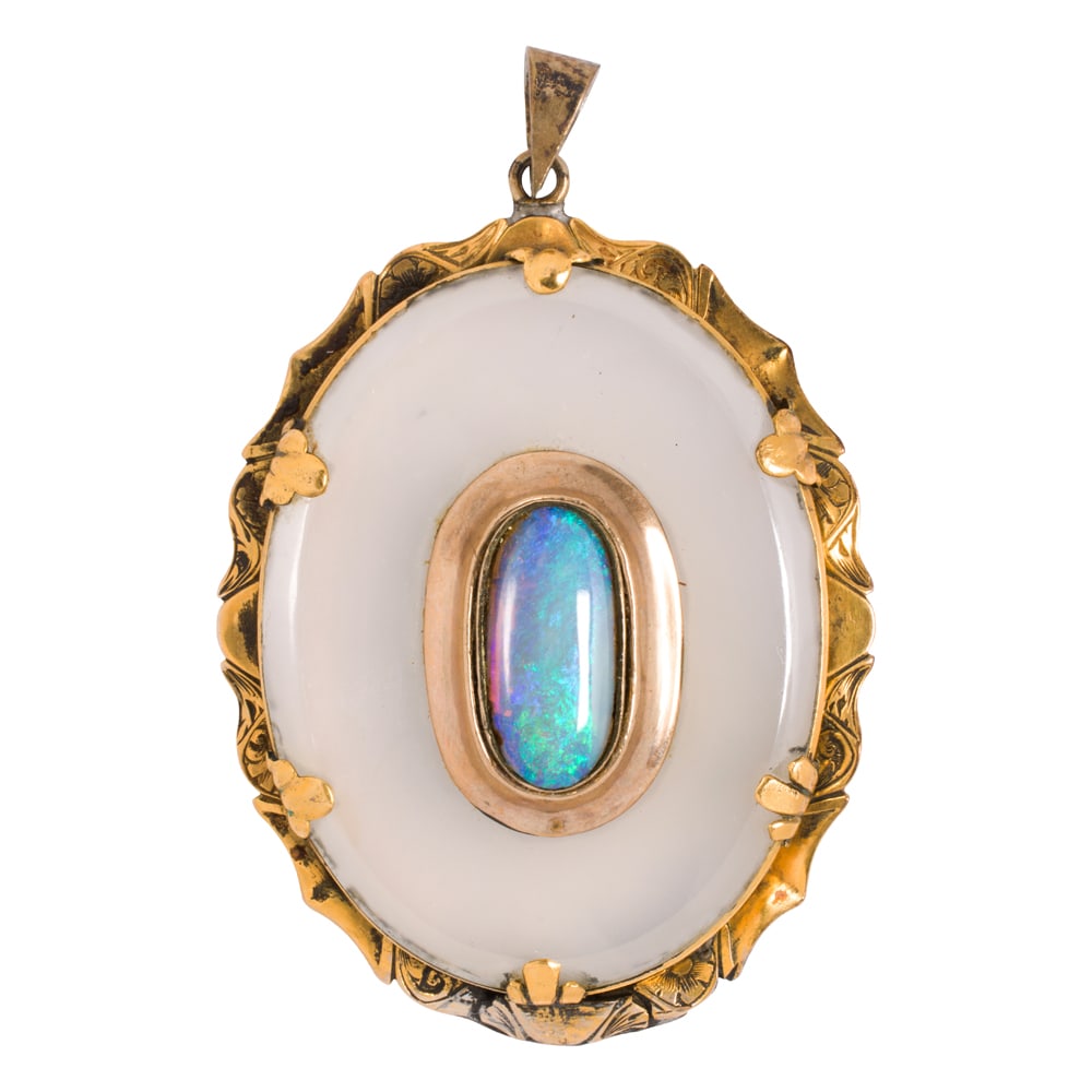 An antique opal, hardstone and 14k gold pendant: An antique opal, hardstone and 14k gold pendant centering an oval-shaped opal cabochon measuring approximately 16.3 x 8.69mm (depth not accessible), within a white hardstone carving with gold frame;