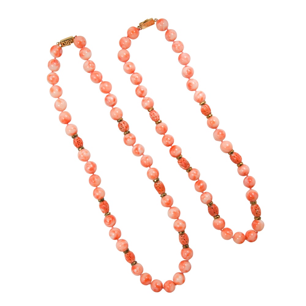 A pair of coral and 18k gold necklaces: A pair of coral and 18k gold necklaces Of similar design, featuring round-shaped coral beads measuring 11.42 mm, interspersed by hollow-form carved beads and 18k gold spacers; lengths: 20 1/2 and 18 i