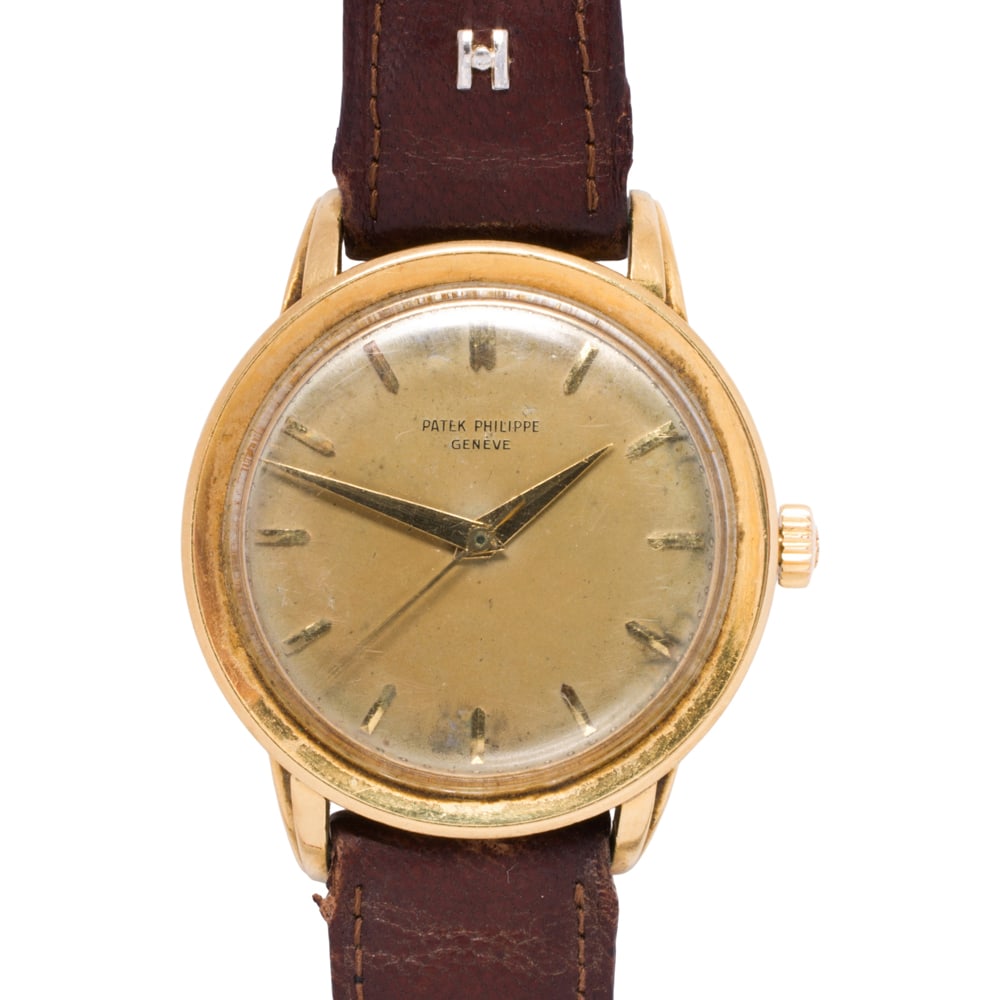 A 1950s Patek Philippe Calatrava 18k gold wristwatch: A 1950s Patek Philippe Calatrava 18k gold wristwatch Ref: 2481Case no.: 696332Movement no.: 706320The brown tone face with gold baton indices and gold dauphine hands, within 18k gold case containing a