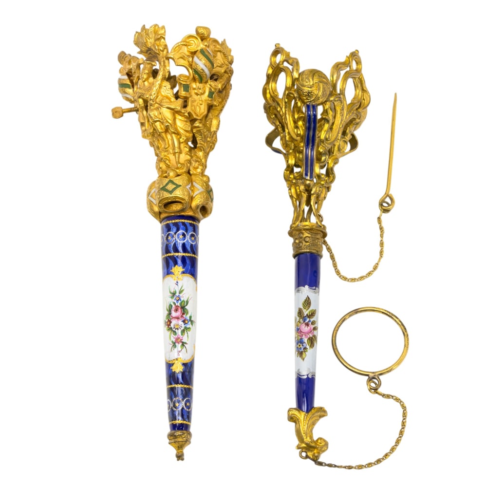 Two French gilt metal and enamel posy holders or tussie mussies: Two French gilt metal and enamel posy holders or tussie mussies, circa 1880, one cup with figures, the other with ribbon bands, 5.5"l. Provenance: The Collection of Irene Deitsch, Palo Alto,