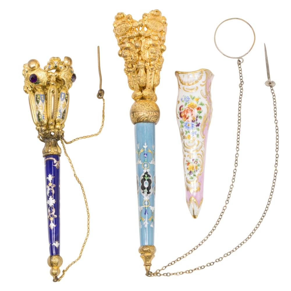 Two French enamel and gilt metal posy holders or tussie mussies and a porcelain holder: Two French enamel and gilt metal posy holders or tussie mussies and a porcelain holder, circa 1860-1880s, the first with turquoise handle; the second with paste jewel and enamel decorated cup on