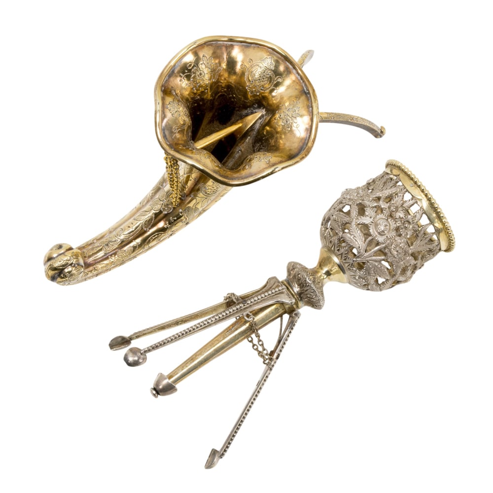 Two English silver posy holders or tussie mussies: Two English silver posy holders or tussie mussies, circa 1870-1880, the first sterling tripod holder with pierced floral cup, hallmarked, fitted in presentation case; the second cornucopia with