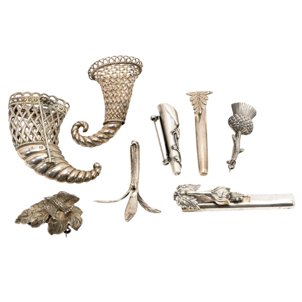 Eight silver and white metal posy brooches and lapel holders: Eight silver and white metal posy brooches and lapel holders, late 19th century, comprising three silver gentleman's buttonhole holders of cylindrical tube form; a white metal gentleman's lapel