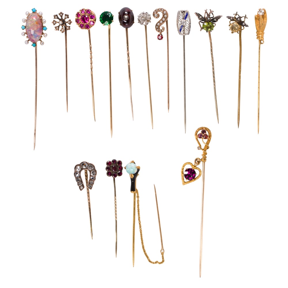 A collection of gem-set stickpins: A collection of gem-set stickpinscomprising 15 pins, variously set with stones including diamond, seed pearl, peridot, opal, garnet, synthetic ruby, tourmaline and glass, in 9k - 14k gold, silver and