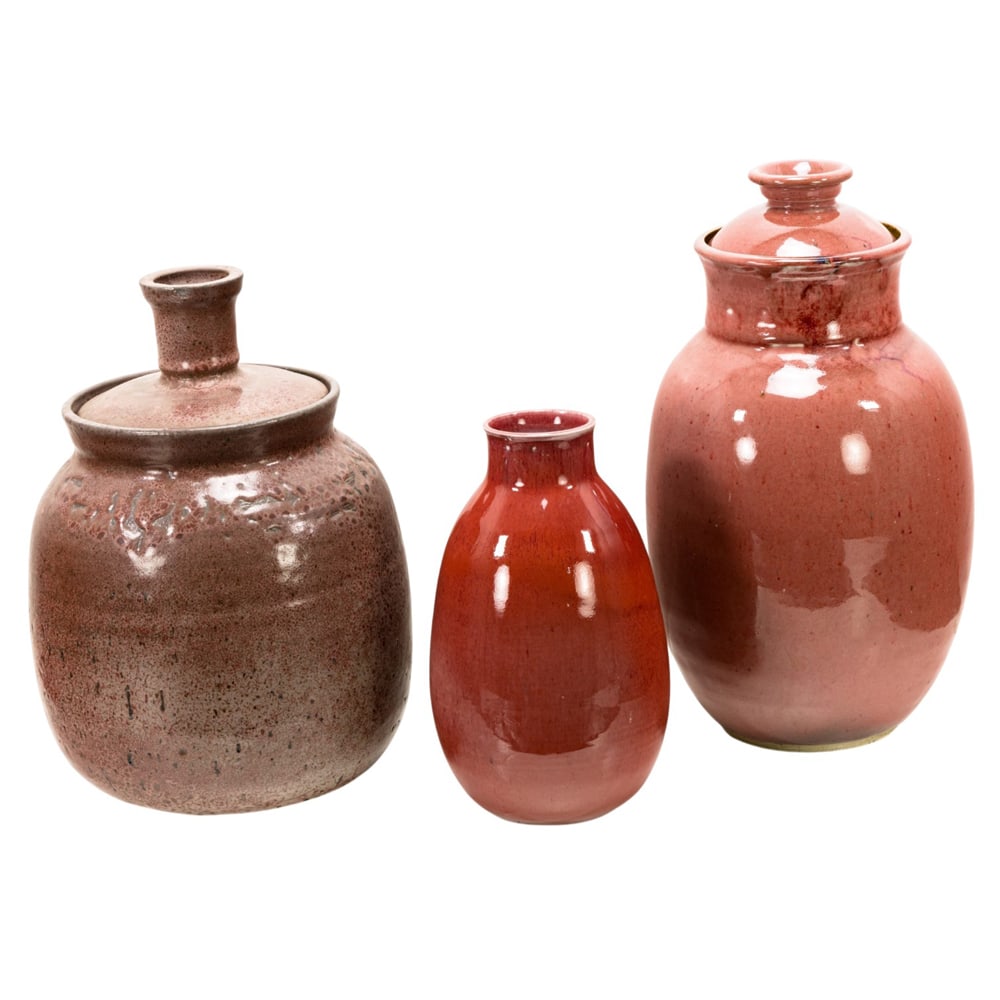 Ceramic Vessels, Vernon Coykendall: (lot of 3) Vernon Coykendall (American, 1907-1995), Red Glazed Vessels, two ceramic lidded urns and one vase, each signed beneath, overall (for largest): 15"h x 8"w x 8"d. Provenance: Property from