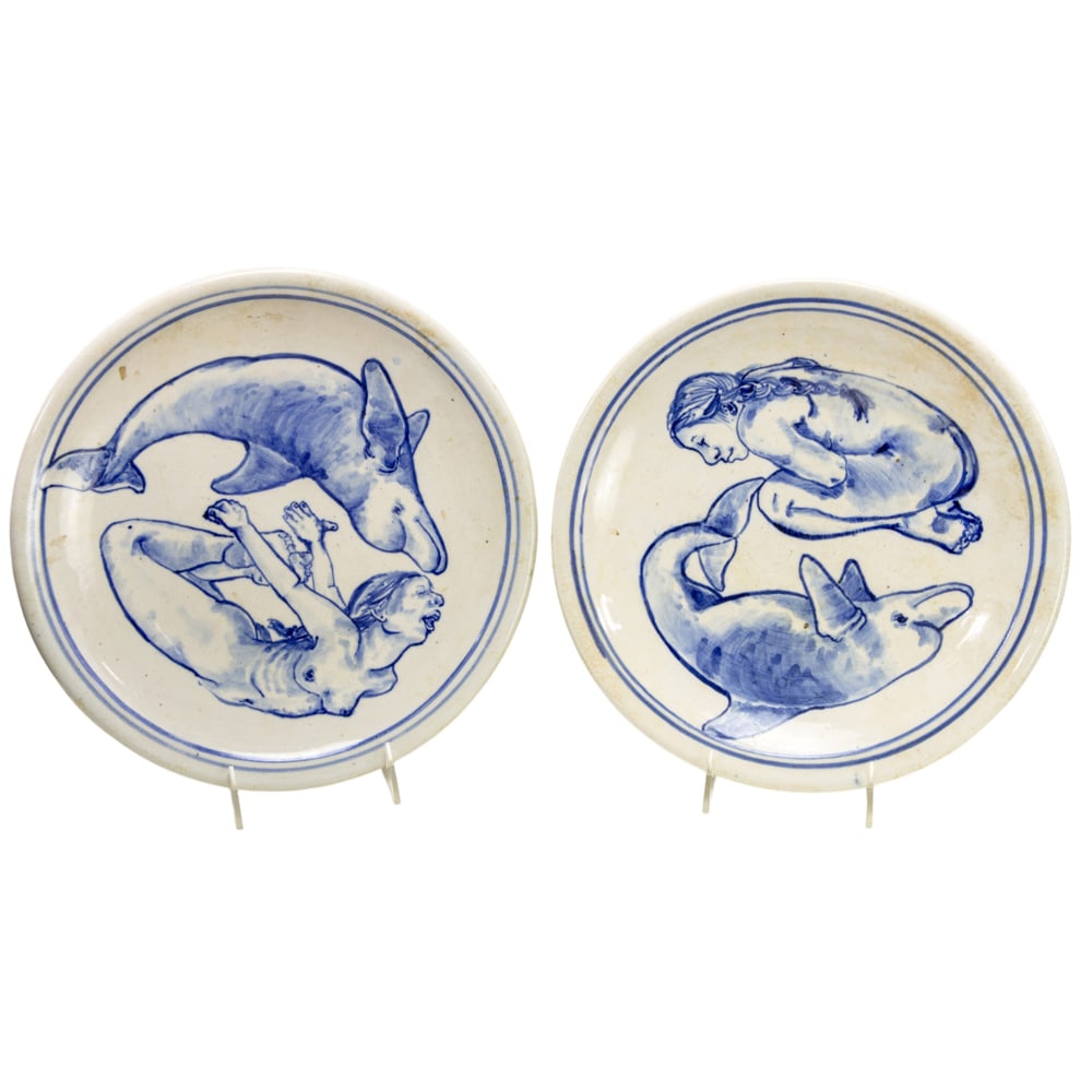 Pair of Ceramic Plates, Tre Arenz: (lot of 2) Tre Arenz (American, 1953-2003), Mermaid Plates, 1976, ceramic dishes, each signed and dated beneath, overall: 1"h x 12"w x 12"d. Provenance: Property from the Private Collection of Viola