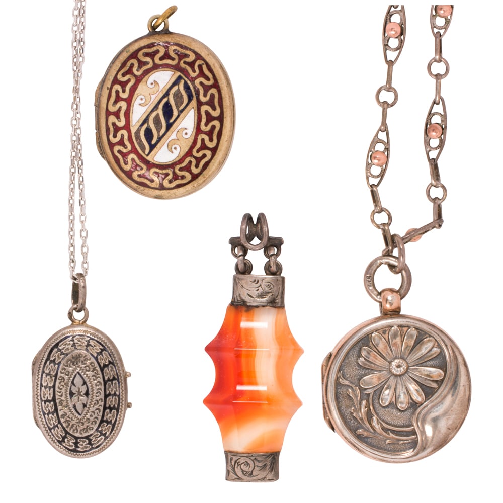 A group of antique jewelry: A group of antique jewelry comprising two silver lockets on chains, one gold fill locket and a silver and agate pendant; locket lengths: 1 - 1 1/4 in; chain lengths: 18 and 20; pendant length: 1 1/2;