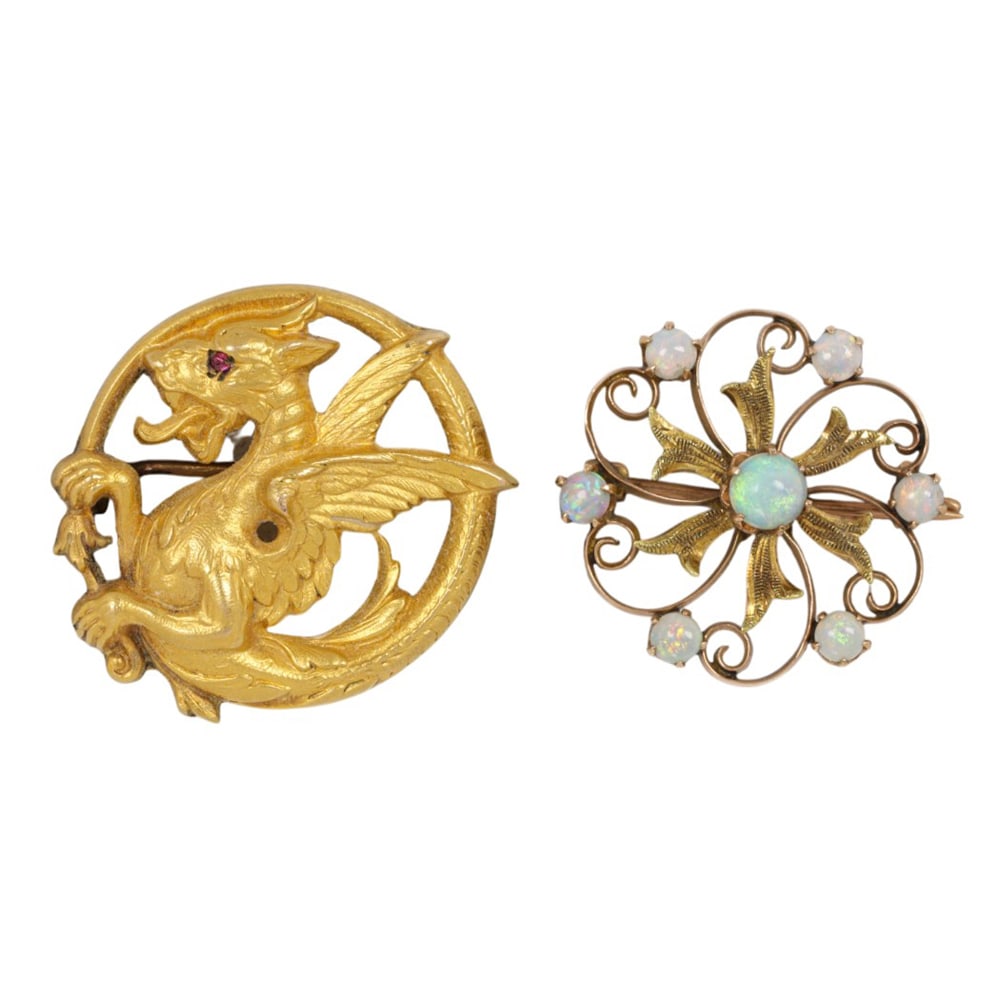 One 9k gold and one gold-filled pin: One 9k gold and one gold-filled pin Comprising one opal and 9k gold pin, together with one gold-filled griffin pin; widths: 7/8 and 1 in, respectively; gross weight: 4.75 grams