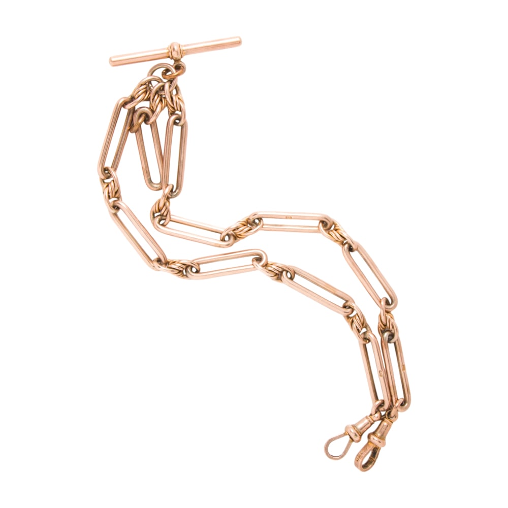 An antique gold-filled pocket watch chain: An antique gold-filled pocket watch chain Of fancy-link design; length: 15 in; 27.25 grams