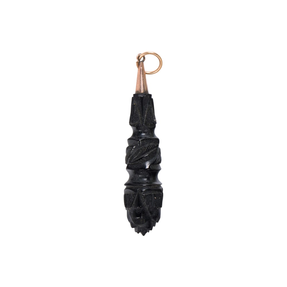 An antique Whitby Jet pendant: An antique Whitby Jet pendant The droplet shaped carving set with gold-filled bail; length: 2 1/2 in; 3.85 grams