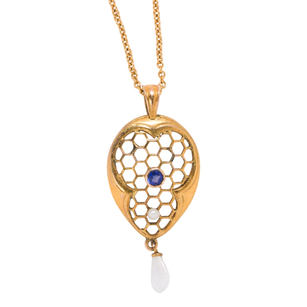 An antique sapphire, river pearl, 10k gold, and gold-filled pendant necklace: An antique sapphire, river pearl, 10k gold, and gold-filled pendant necklace The 10k gold pendant of honeycomb design, set with one round-cut sapphire, one seed pearl, and a river pearl measuring