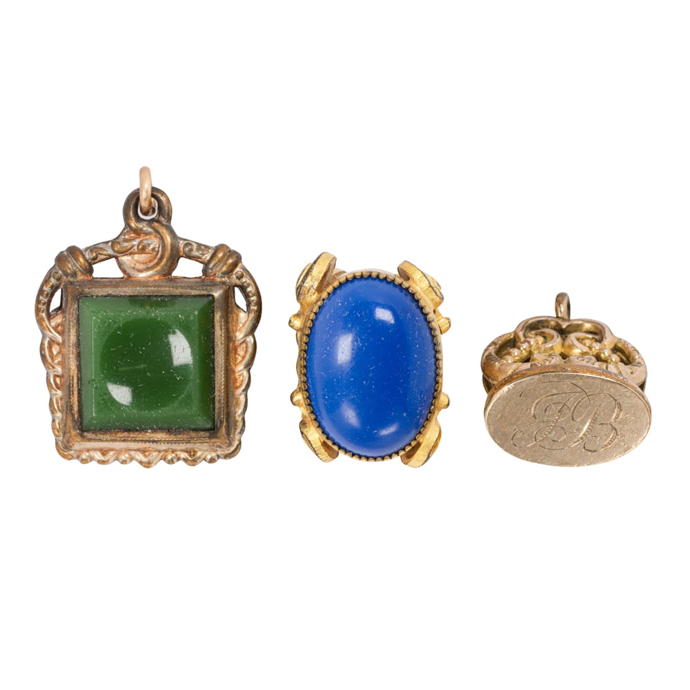 Three antique gold-filled watch fobs: Three antique gold-filled watch fobs The fobs of varying styles and designs; gross weight: 18.75 grams