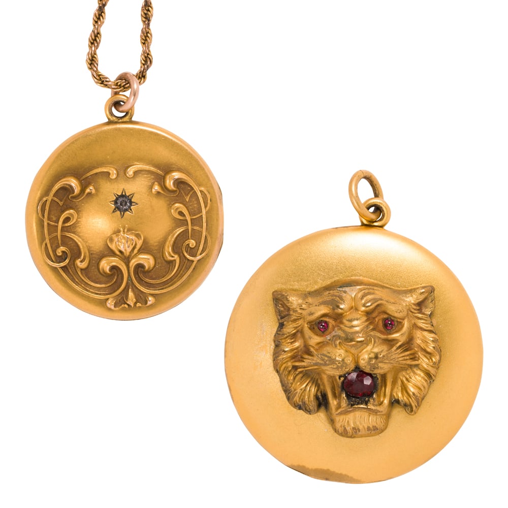 Two antique gold-filled lockets and 10k gold chain: Two antique gold-filled lockets and 10k gold chain Comprising one lions head locket pendant set with three round-cut red stones, together with an embossed floral locket set with one round-cut