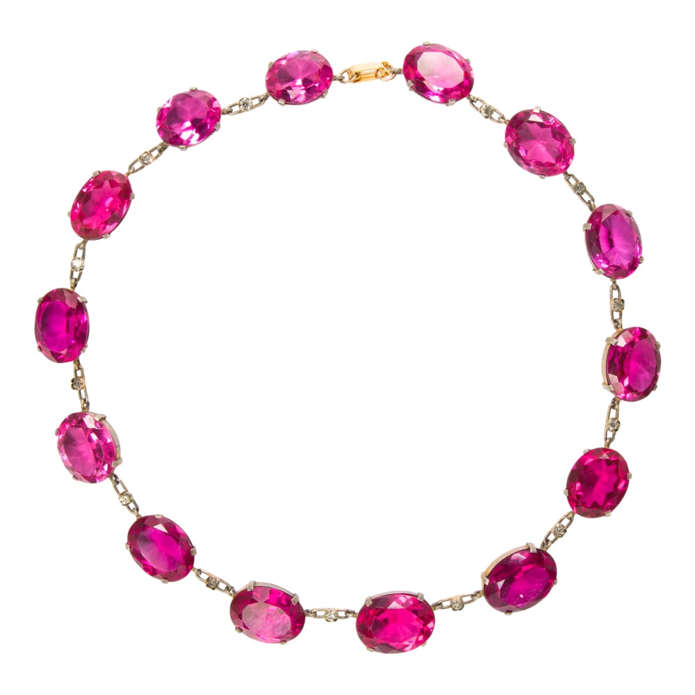 A glass necklace: A glass necklace Set with 14 oval-cut glass gemstones; length: 16 in; 63.45 grams