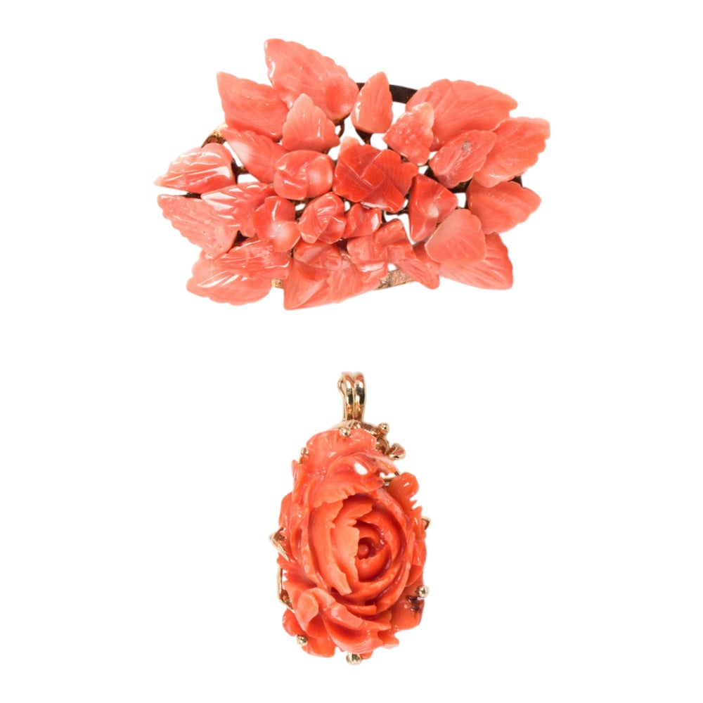 A carved coral pendant and brooch: A carved coral pendant and brooch The pendant and brooch carved into floral patterns; pendant length: 1 3/8 in; brooch width: 2 in; gross weight: 17.70 grams