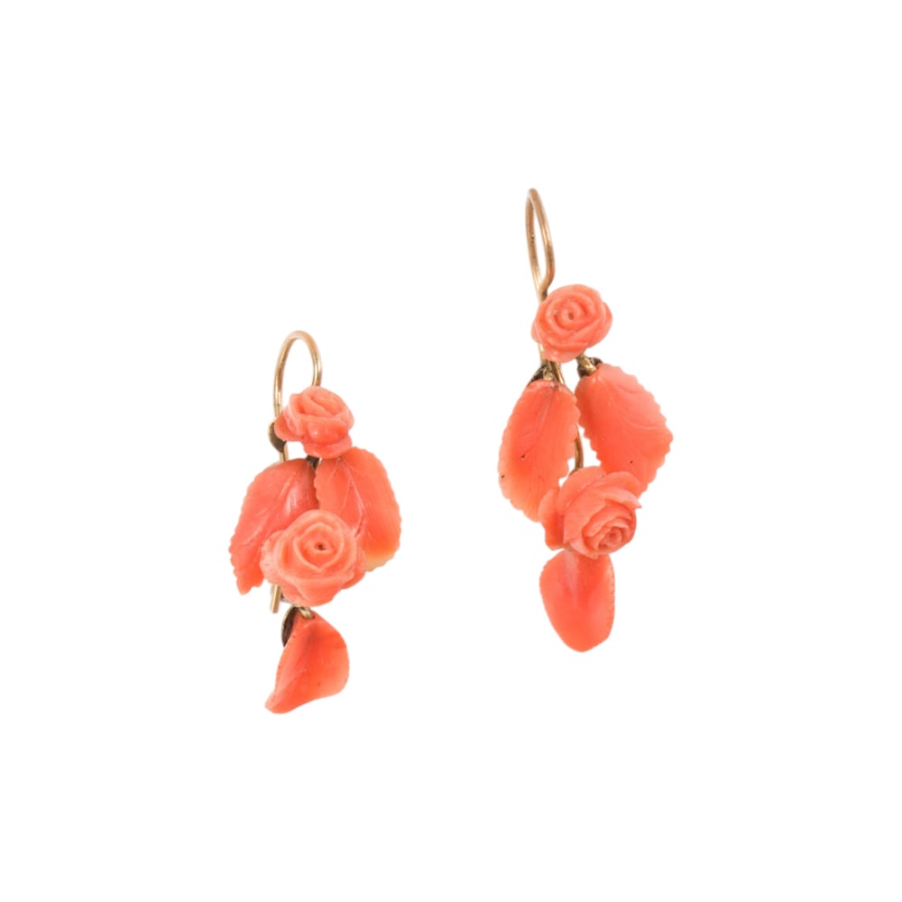 A pair of carved coral earrings: A pair of carved coral earrings Of rose design; length: 1 1/2 in; 5.50 grams