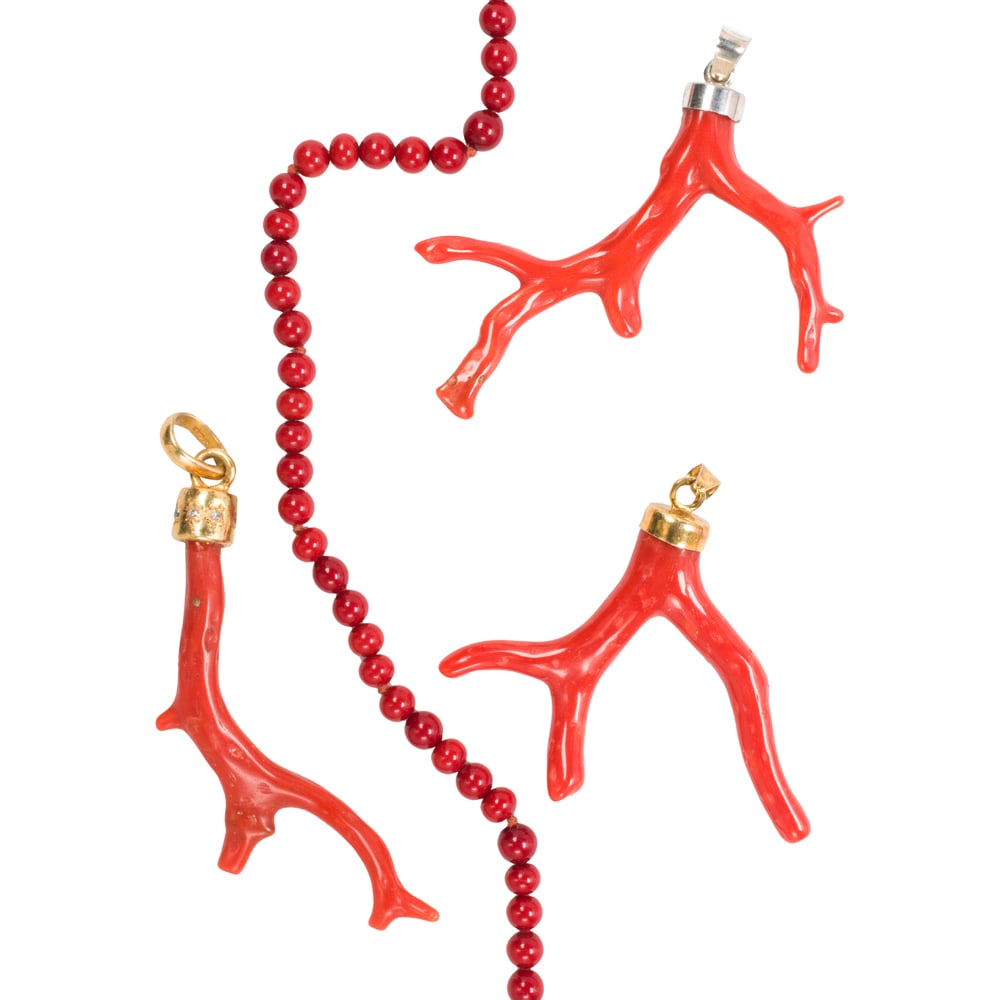 A coral and silver group: A coral and silver group Comprising three polished coral branch pendants set in sterling silver, together with one coral beaded necklace featuring round-shaped coral beads measuring 3.68 mm; necklace