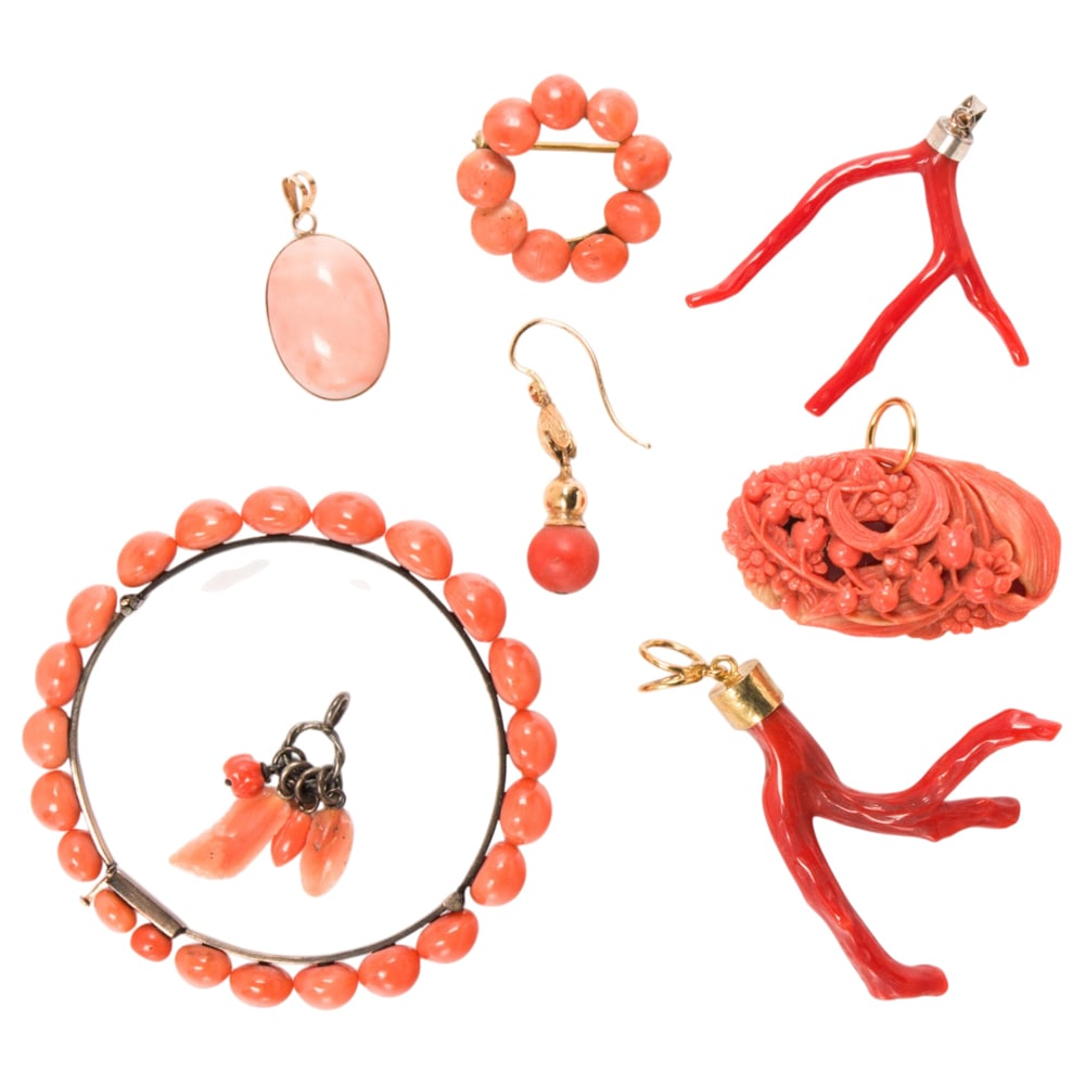 A miscellaneous group of coral jewelry: A miscellaneous group of coral jewelry Comprising five pendants, one pin, one bracelet, and one earring of varying styles and materials including gold; gross weight: 41.10 grams