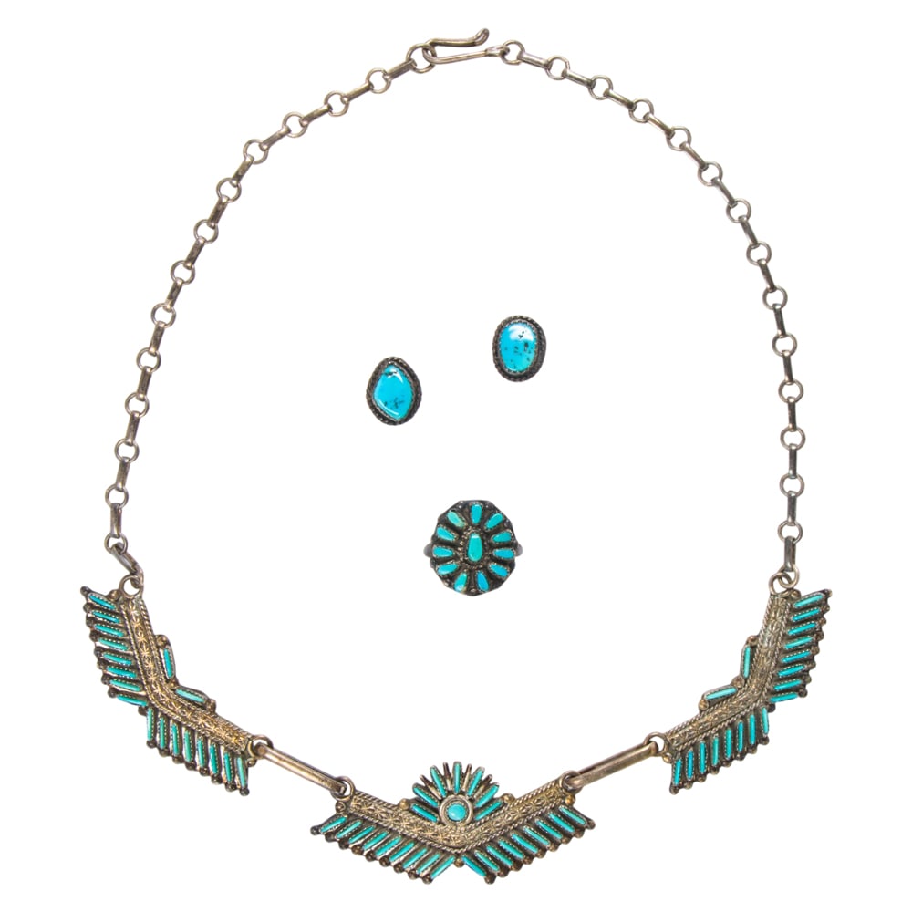 A group of turquoise and silver jewelry: A group of turquoise and silver jewelry comprising a necklace, ring and pair of stud earrings all set with turquoise of varied size and shape; necklace length: 17 1/2 in; ring size: 6; earring