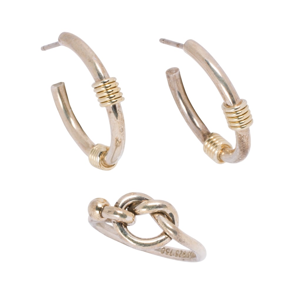 A pair of Tiffany & Co. sterling silver and 18k gold earrings and ring: A pair of Tiffany & Co. sterling silver and 18k gold earrings and ring Featuring the love-knot ring, together with a pair of coil hoop earrings; accompanied by box; size 7 1/4; earring length: 1 in;