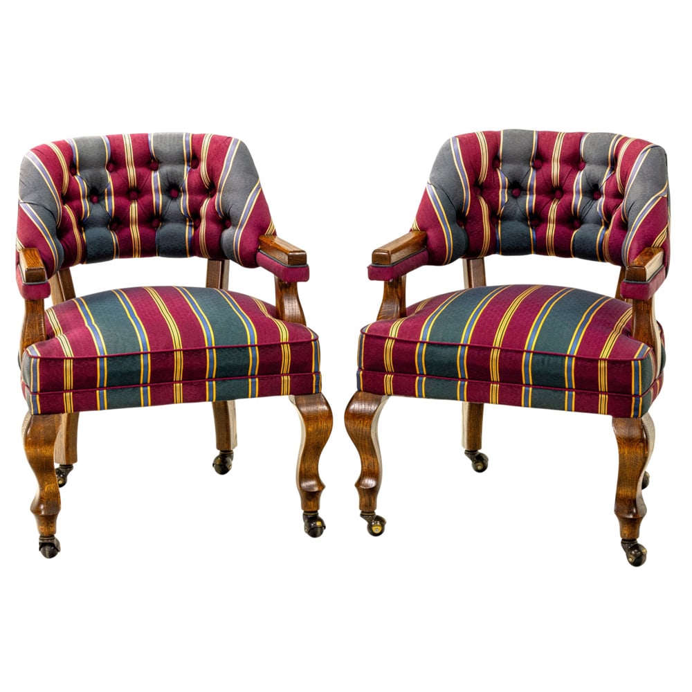 A set of four game chairs: A set of four game chairs, with striped upholstery and resting on casters, 31.5"h x 25"w x 20.5"d (overall); 18.5"h x 20.5"d (seat)