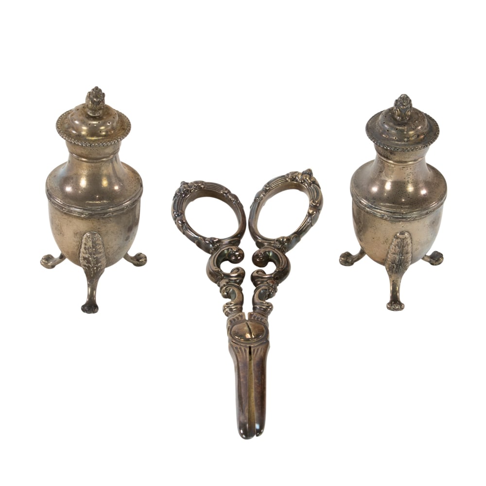 A sterling pair of tripod pepper casters, Tiffany & Co: A sterling pair of tripod pepper casters, Tiffany & Co., circa 1891-1902, H. 3 3/4 in., (4.62 oz t.); with a plated pair of grape shears by Tiffany.