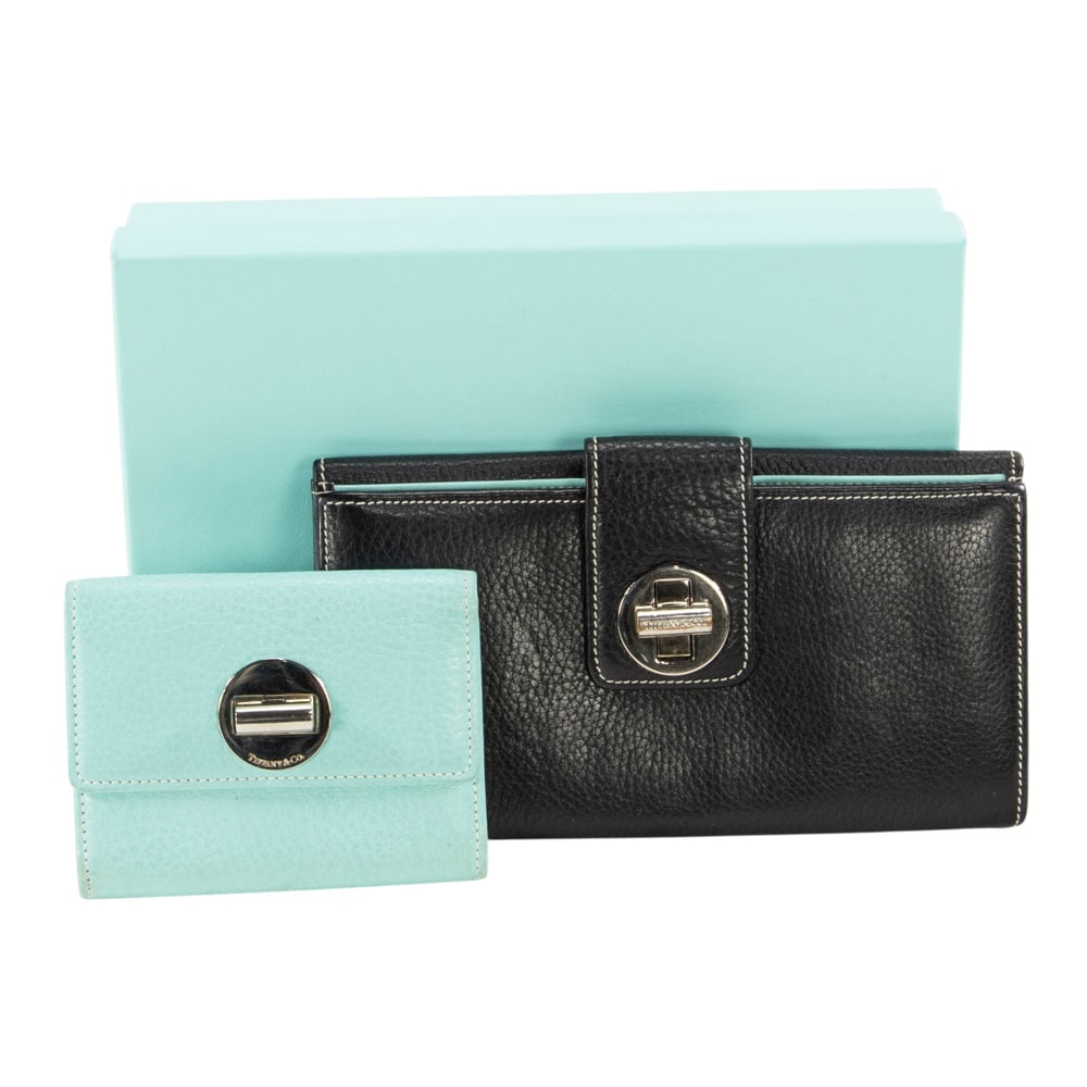 Two Tiffany & Co. turn-lock pebbled leather wallets: Two Tiffany & Co. turn-lock pebbled leather wallets, the first black Continental wallet with Tiffany blue lining, 4.5"h x 7.5"l; the second leather compact wallet in Tiffany blue, 3"h x 4.25"l