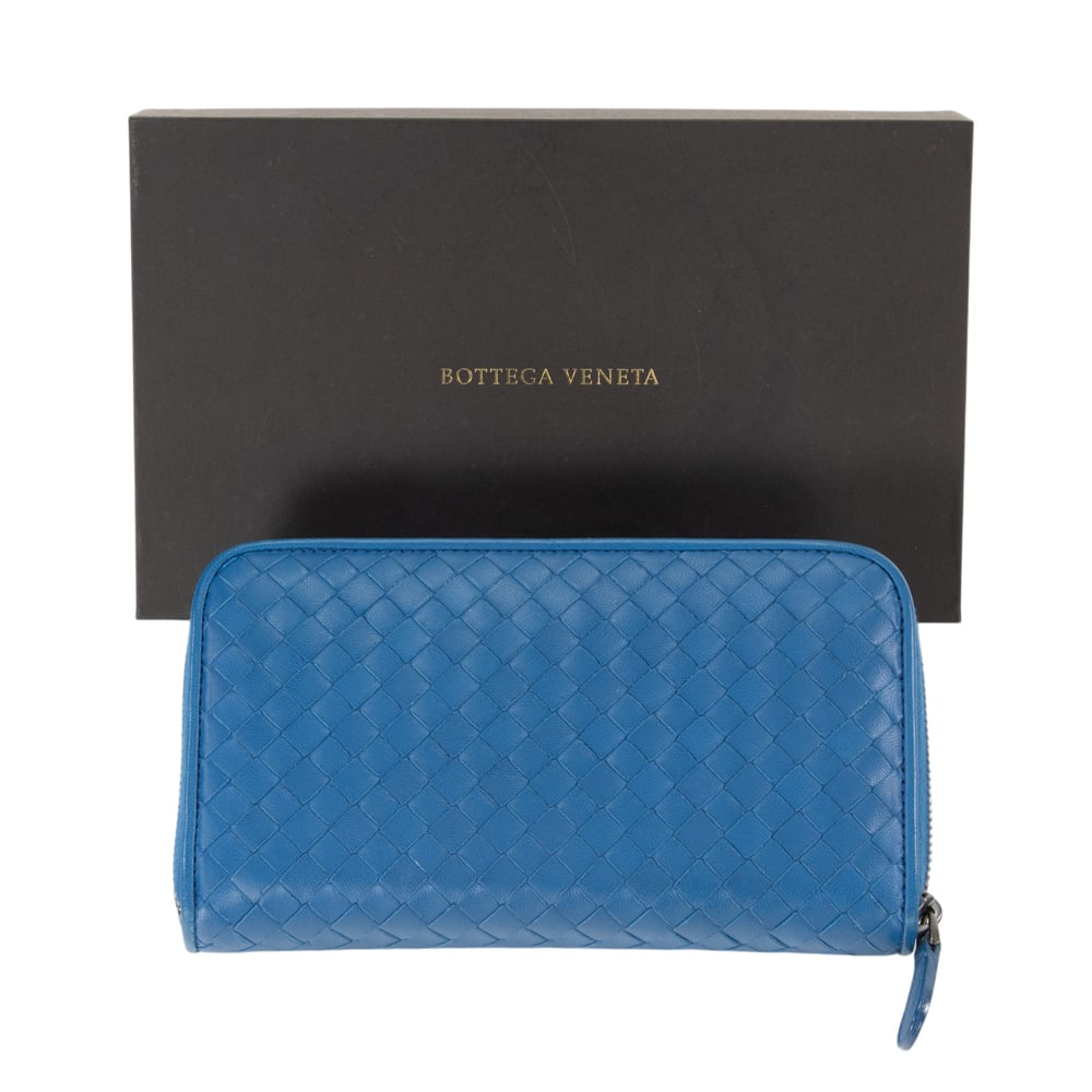 A Bottega Veneta blue intrecciato leather Continental wallet: A Bottega Veneta blue intrecciato leather Continental wallet, featuring gunmetal hardware and leather-lined interior, includes dust bag and original box, 4.25"h x 7.5"l