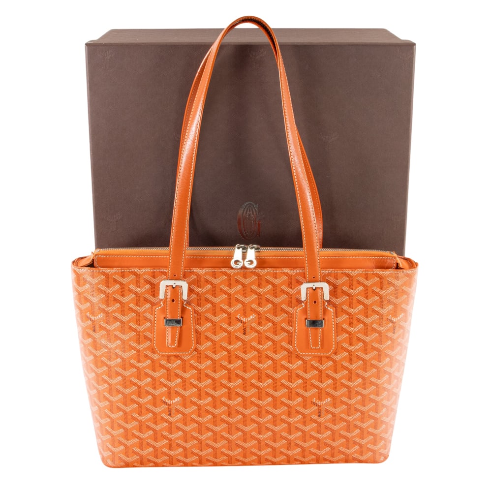 A Goyard orange Goyardine coated canvas Marie-Galante MM shoulder bag: A Goyard orange Goyardine coated canvas Marie-Galante MM shoulder bag, featuring silver toned hardware, leather trim, zip closure, protective feet at base, handbag with original dust bag, labels and b
