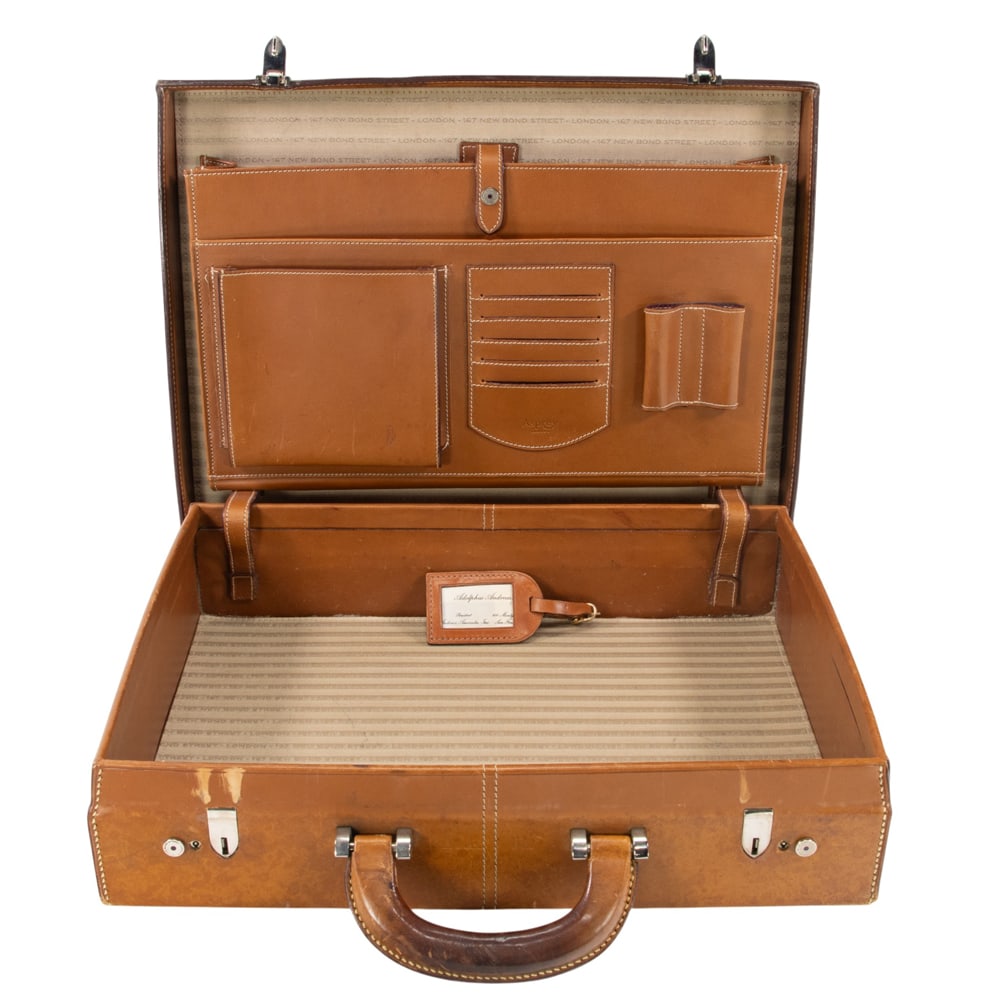 An Asprey leather hardside briefcase: An Asprey leather hardside briefcase, featuring silver tone hardware and leather compartments to interior, monogrammed 'AA Jr', 13"h x 18"w x 4.5"d. Provenance: The Collection of Adolphus Andrews Jr. 