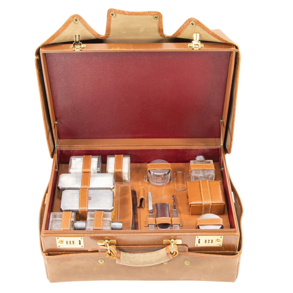 An Asprey leather traveling toiletry case with S. T. Dupont silver mounted fittings: An Asprey leather traveling toiletry case with S. T. Dupont silver mounted fittings, of rectangular outline with two sections, the upper section with lift up tray for fittings, monogrammed 'AA Jr', in