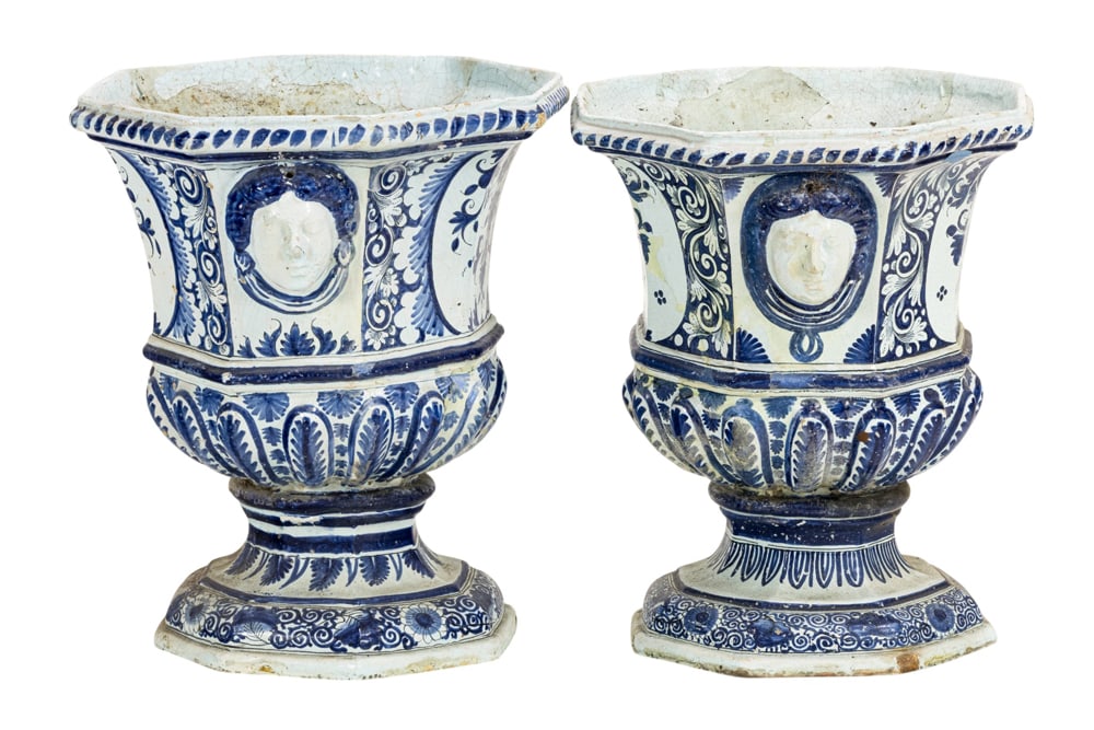 A pair of French faience or Delft blue and white orangerie urns: A pair of French faience or Delft blue and white orangerie urns, 18th/19th century, each of octagonal outline flanked by female masks and decorated with foliate scrolls, unmarked, 24"h x 16"w x 16"d. 