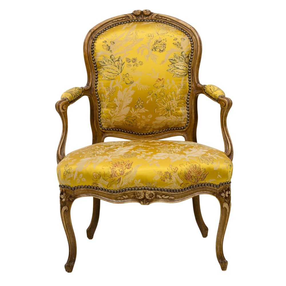 A Louis XV fauteuil by Nicolas Blanchard (received master in 1738): A Louis XV fauteuil by Nicolas Blanchard (received master in 1738), with twin flower head and ribbon-carved frame, padded back, scrolling arms and shaped seat, covered in damask silk, over a molded