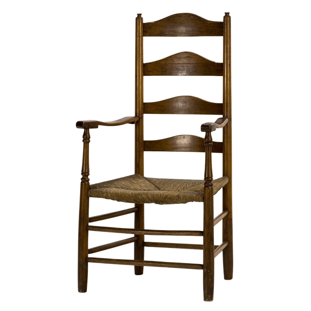 A high back captain's chair: A high back captain's chair, 18th century, the large form with a ladder back terminating at the rush seat, with contoured arms, and rising on turned legs, 45.5"h x 23.5"w x 19.5"d (overall); 17h" x 17